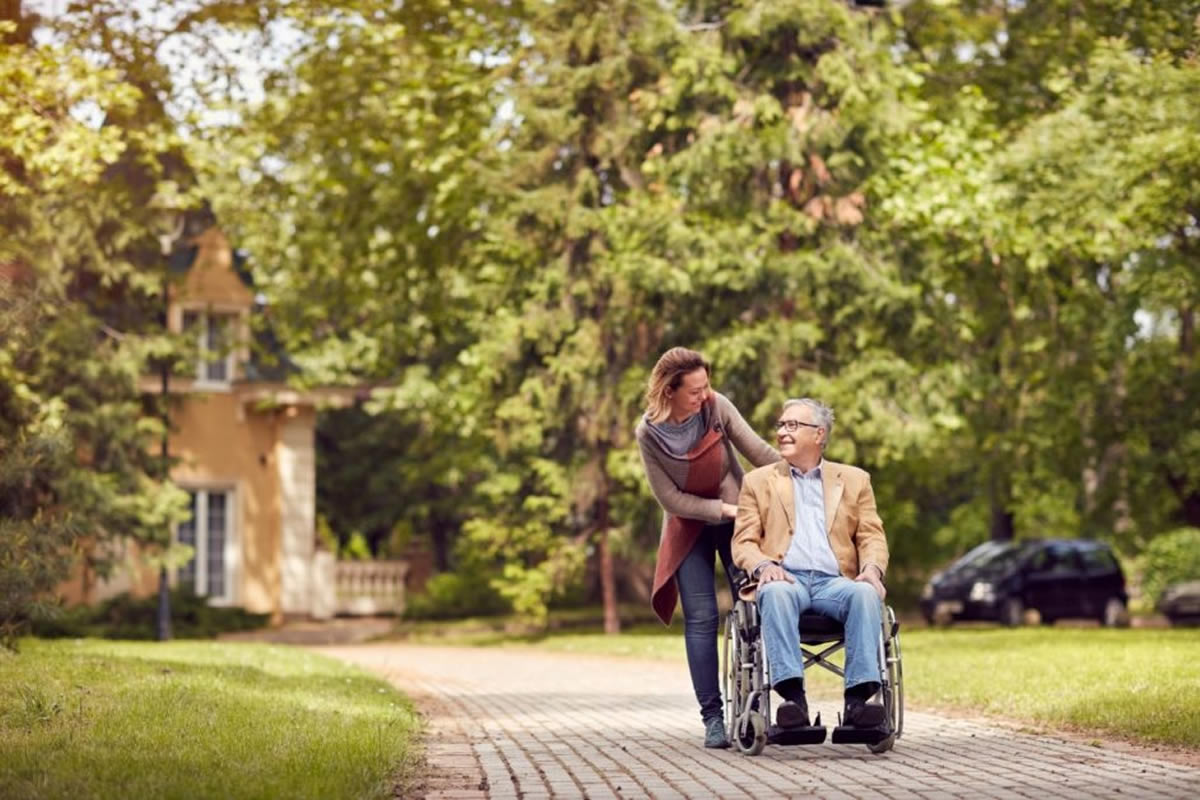 Patient on a wheelchair with caregiver
