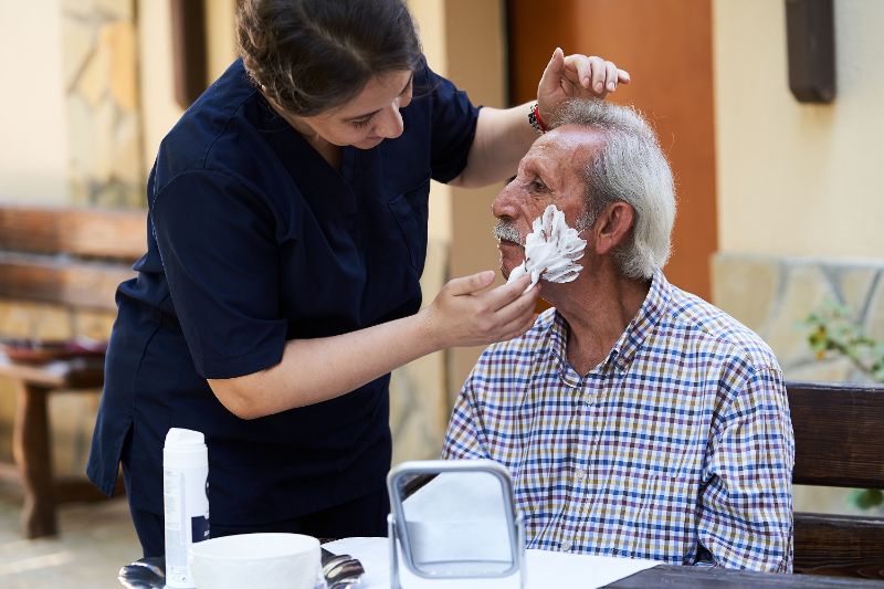 Caregiver assisting with patient's personal care